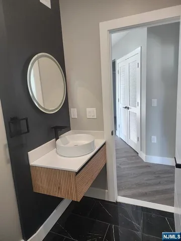a bathroom with a sink a toilet and a mirror