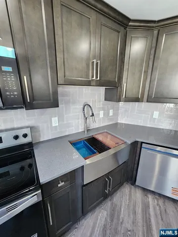 a kitchen with a sink and a refrigerator