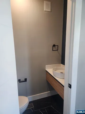 a bathroom with a toilet and a sink