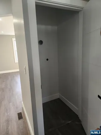 a empty room with wooden floor and white walls