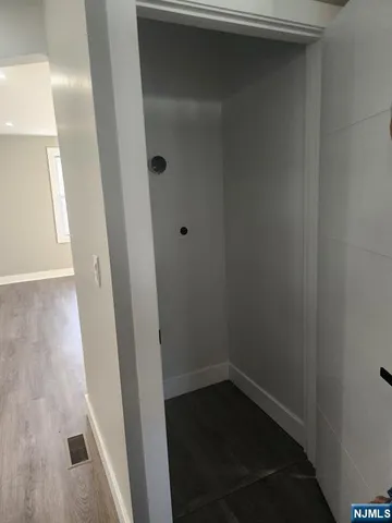 a empty room with wooden floor and white walls