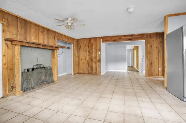 a view of a hallway with closet and a bathroom