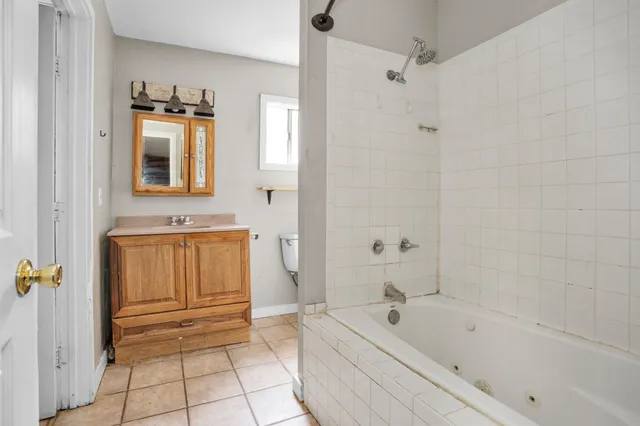 a bathroom with a sink a mirror and a bathtub