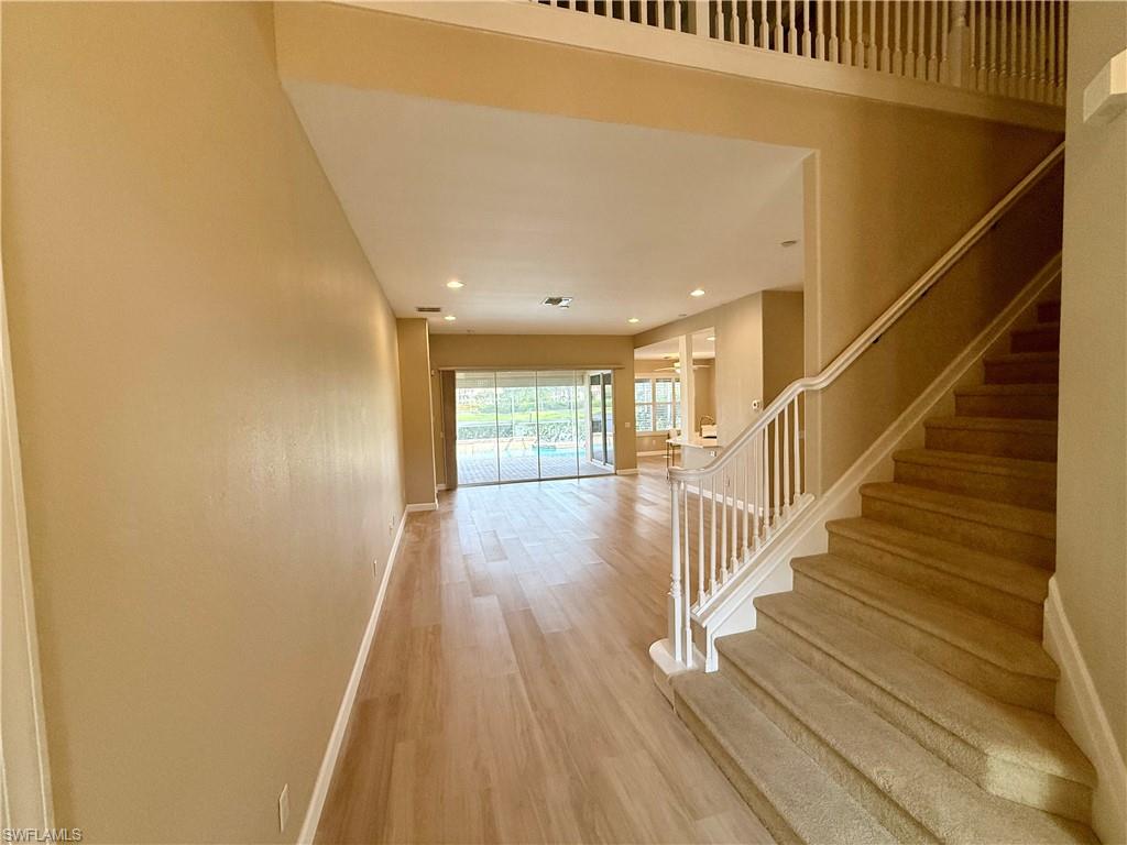 10228 Cobble Hill Road Bonita Springs, FL 34135 - Photo 9 of 31 Stairway with wood finished floors and recessed lighting