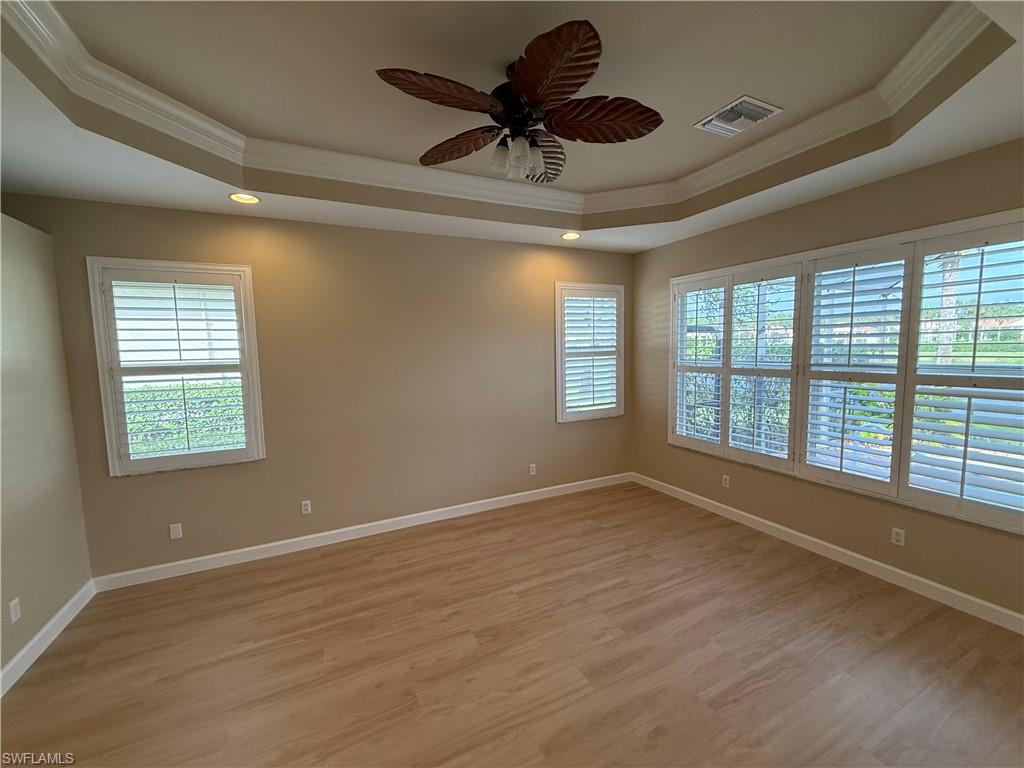 10228 Cobble Hill Road Bonita Springs, FL 34135 - Photo 13 of 31 Unfurnished room with ornamental molding, a raised ceiling, light wood-style floors, ceiling fan, and recessed lighting