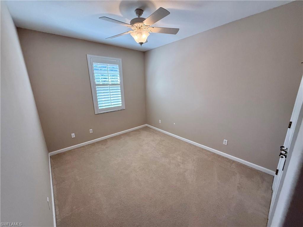 10228 Cobble Hill Road Bonita Springs, FL 34135 - Photo 23 of 31 Spare room featuring carpet flooring and a ceiling fan