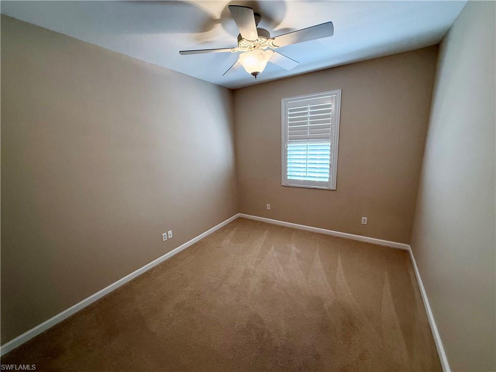 10228 Cobble Hill Road Bonita Springs, FL 34135 - Photo 24 of 31 Empty room with carpet floors and a ceiling fan