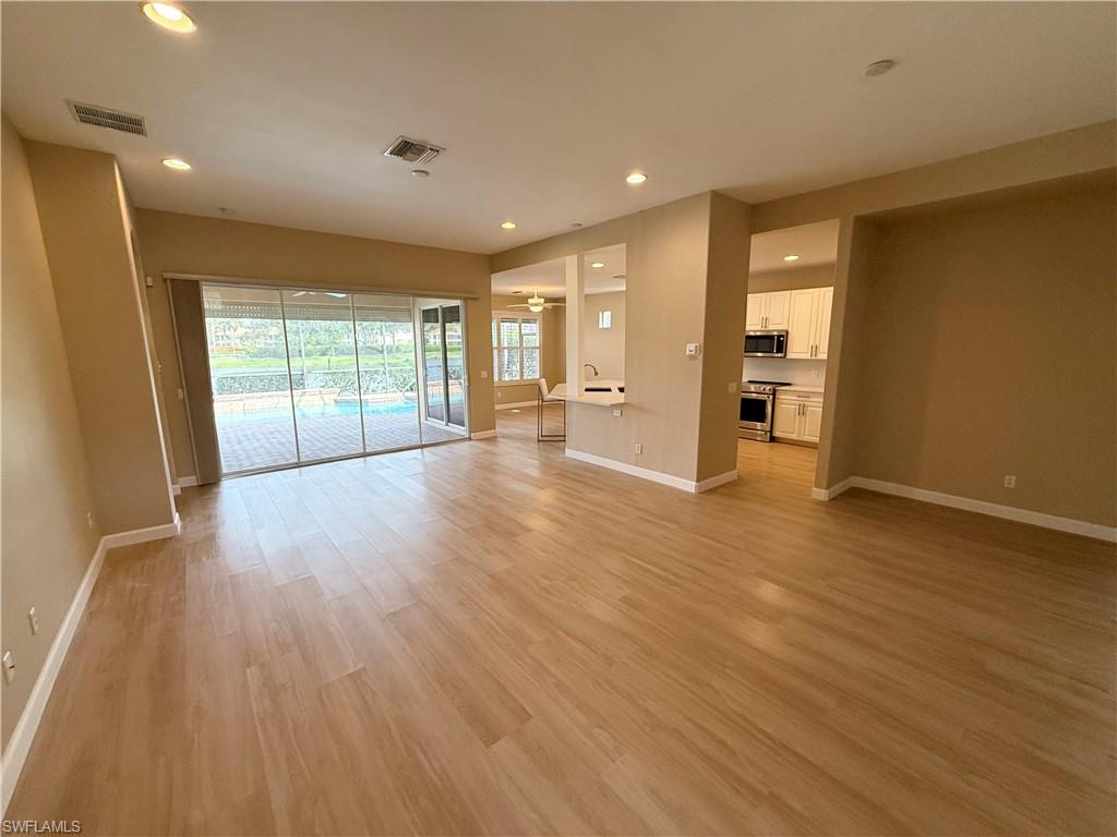 10228 Cobble Hill Road Bonita Springs, FL 34135 - Photo 25 of 31 Empty room with recessed lighting and light wood-style floors