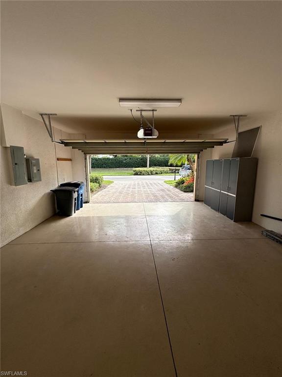 10228 Cobble Hill Road Bonita Springs, FL 34135 - Photo 26 of 31 Garage with electric panel and a textured wall