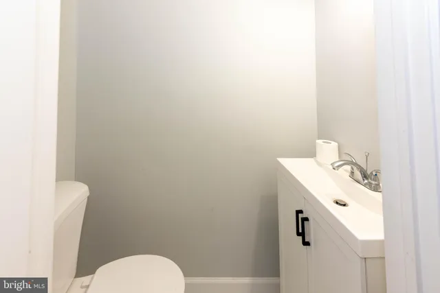 a bathroom with a sink toilet and mirror