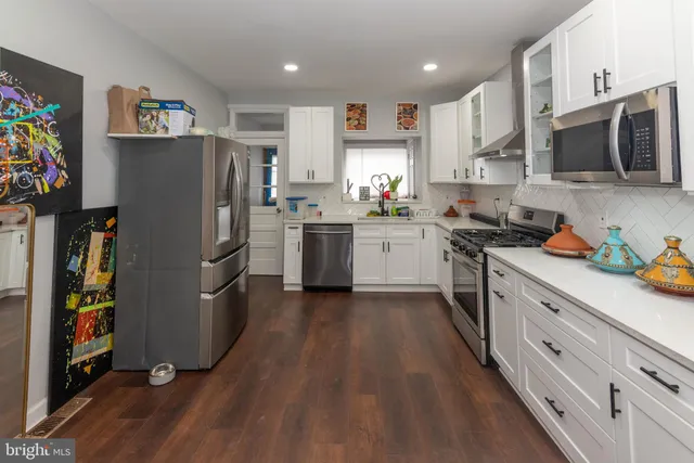a kitchen with stainless steel appliances a refrigerator stove and microwave