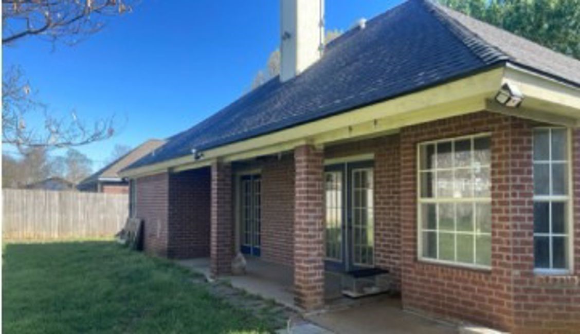 635 Yegua Street Lexington, TX 78947 - Photo 7 of 7 a front view of a house with garden