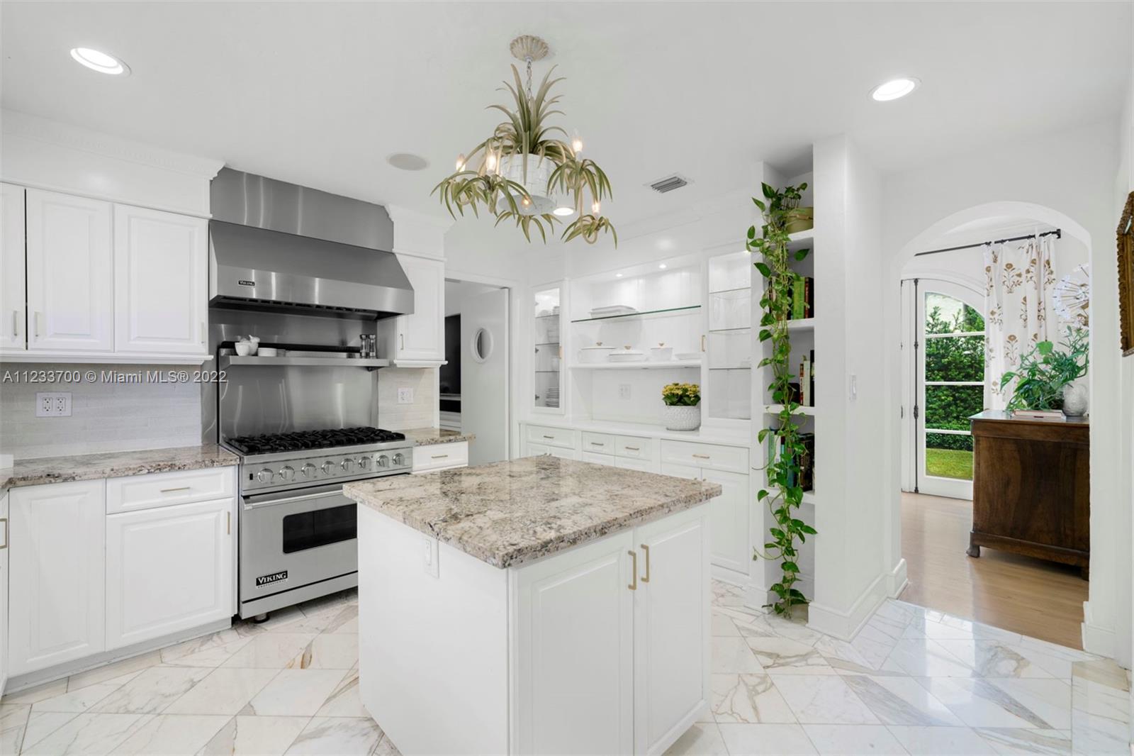 3618 St Gaudens Road Miami, FL 33133 - Photo 13 of 38 a kitchen with stainless steel appliances granite countertop a stove a sink dishwasher and a refrigerator with wooden floor