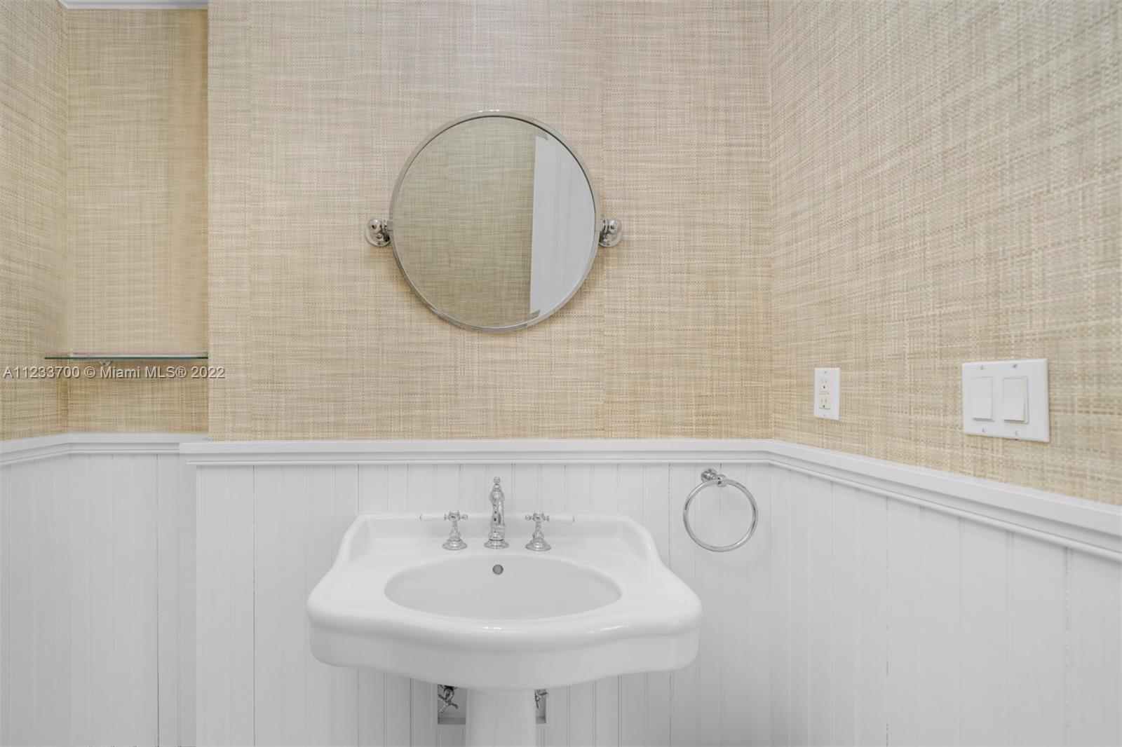 3618 St Gaudens Road Miami, FL 33133 - Photo 18 of 38 a bathroom with a sink and a mirror