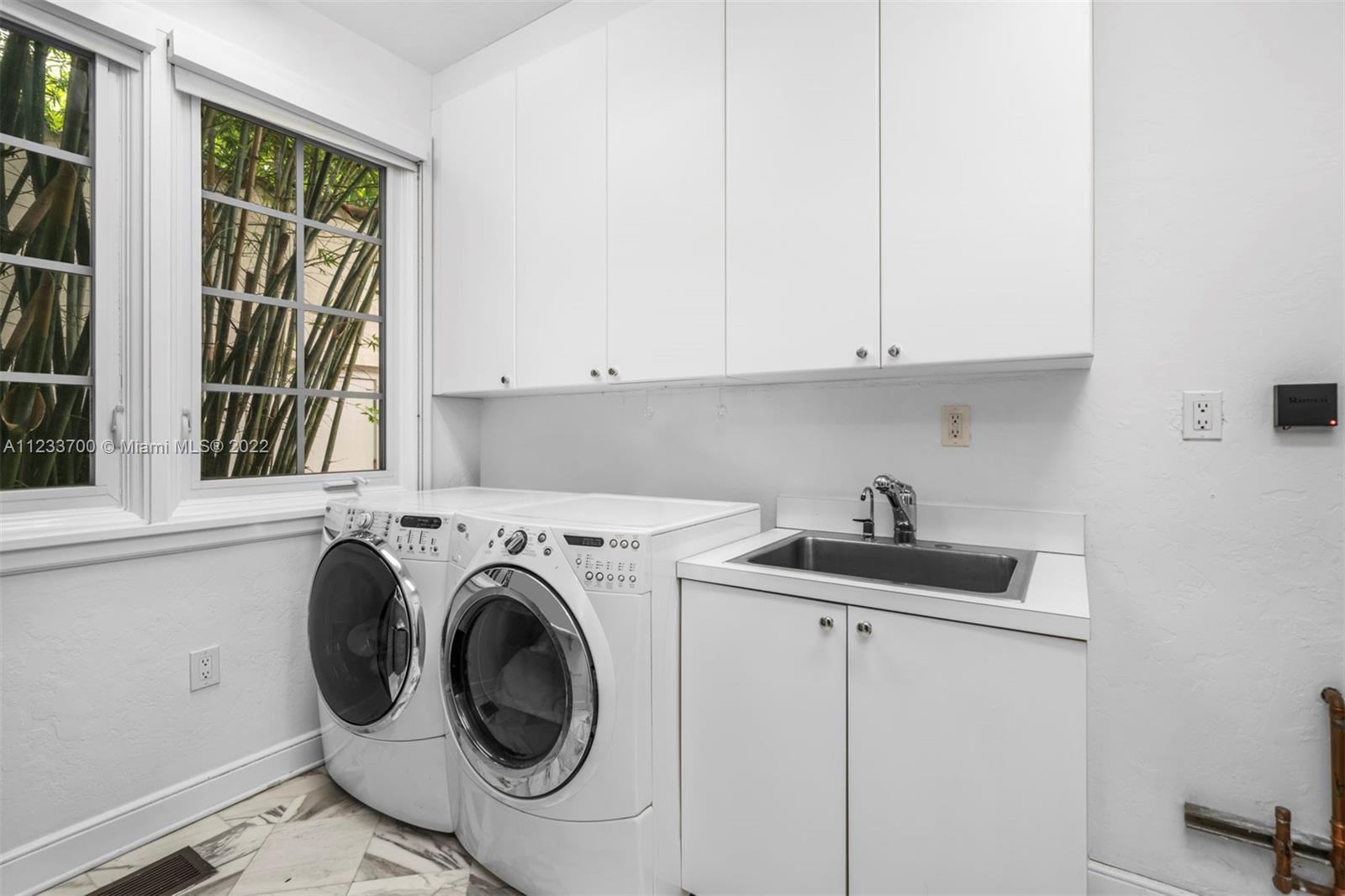 3618 St Gaudens Road Miami, FL 33133 - Photo 19 of 38 a utility room with sink dryer and washer