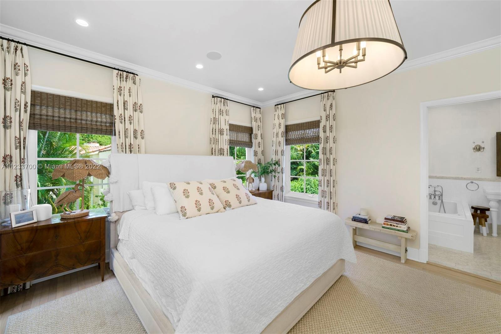 3618 St Gaudens Road Miami, FL 33133 - Photo 20 of 38 a bedroom with a large bed and a chandelier