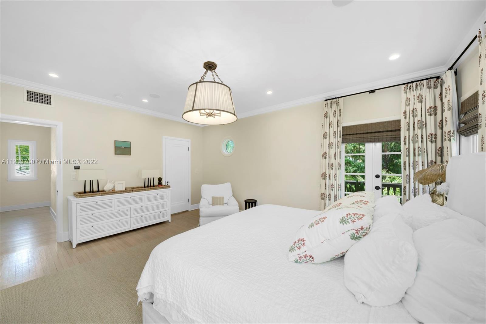 3618 St Gaudens Road Miami, FL 33133 - Photo 21 of 38 a large bed sitting in a bedroom next to a window