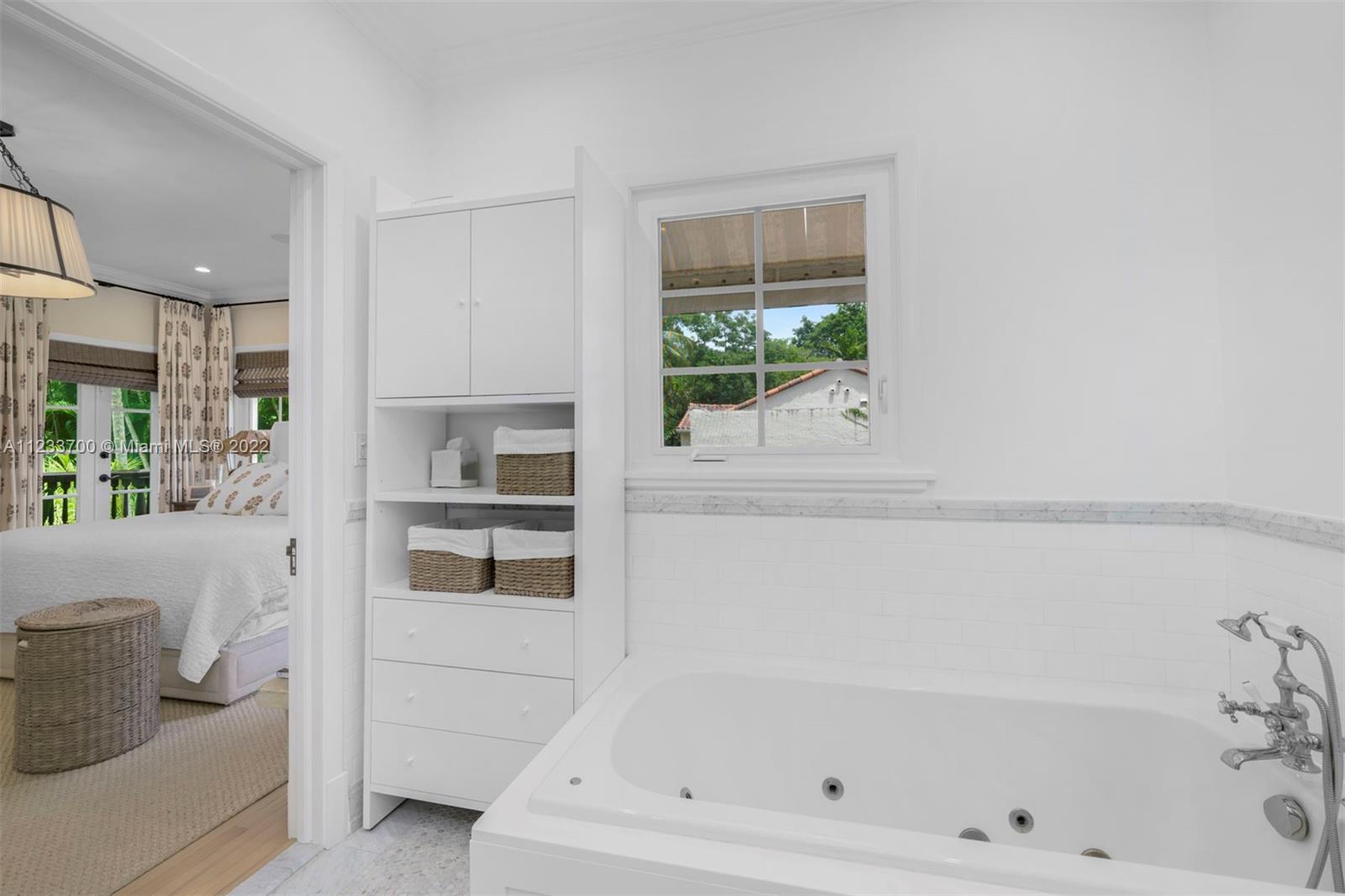 3618 St Gaudens Road Miami, FL 33133 - Photo 22 of 38 a bathroom with a bathtub and a window