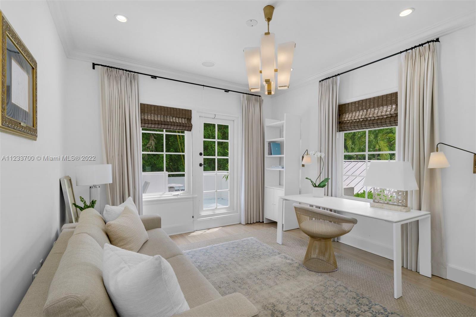 3618 St Gaudens Road Miami, FL 33133 - Photo 26 of 38 a living room with furniture a window and a chandelier