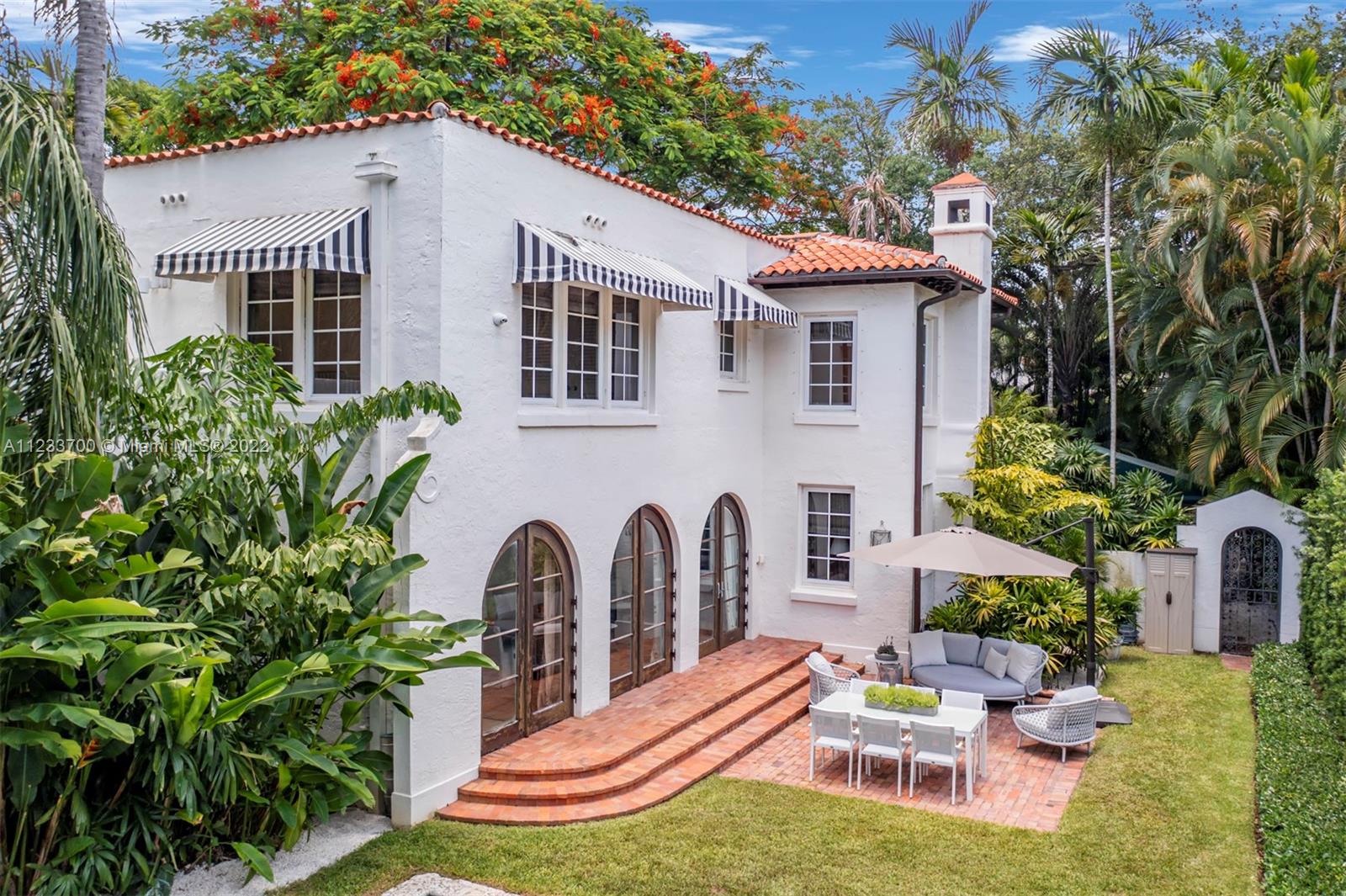 3618 St Gaudens Road Miami, FL 33133 - Photo 29 of 38 a backyard of a house with outdoor seating