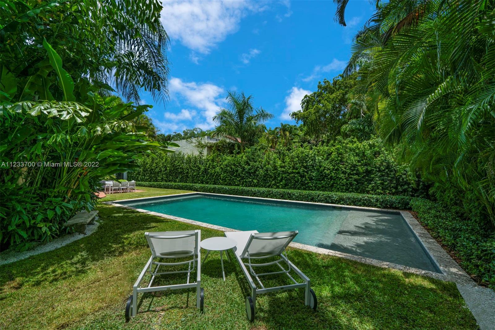 3618 St Gaudens Road Miami, FL 33133 - Photo 32 of 38 a table and chairs in the garden