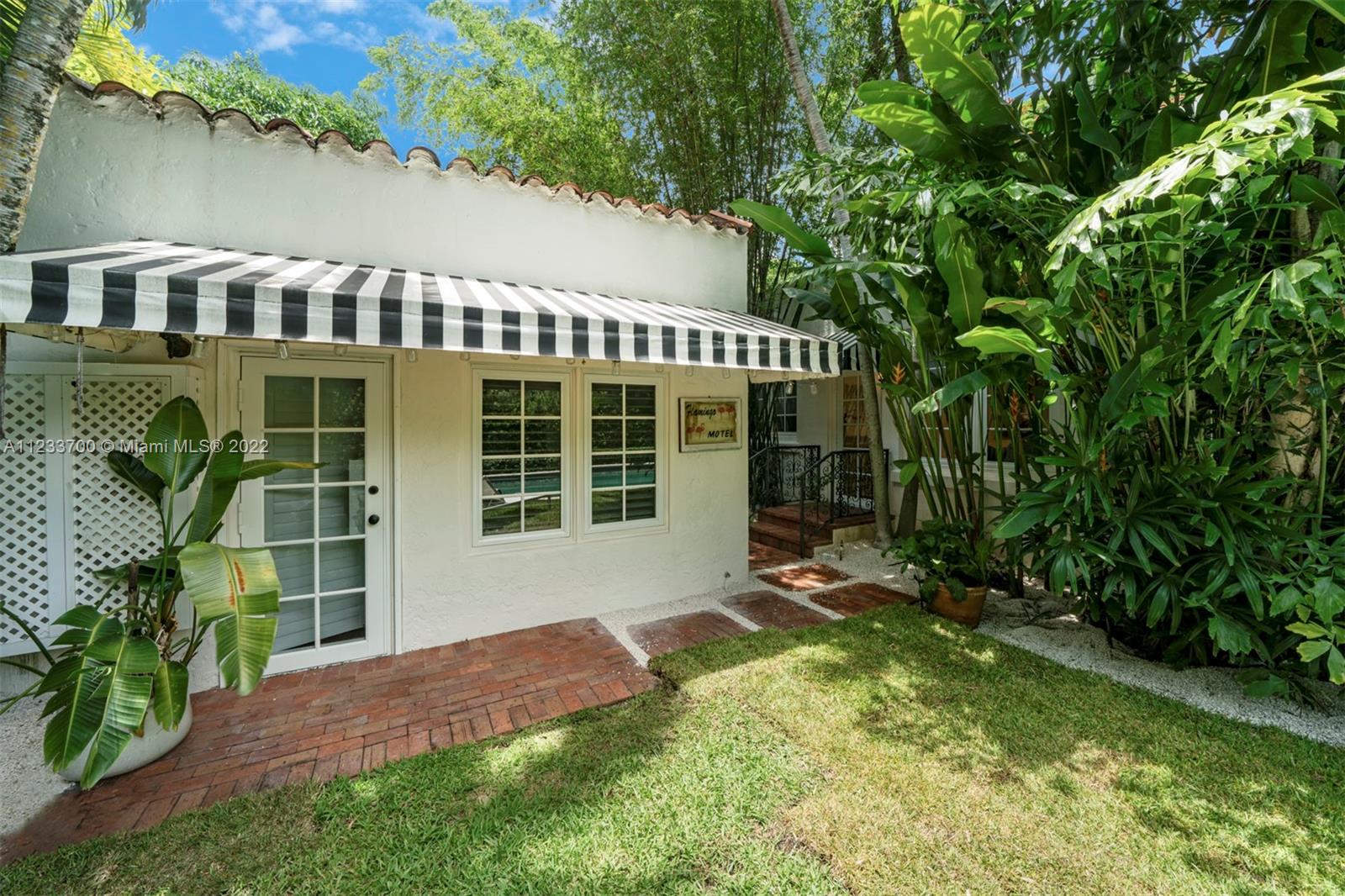 3618 St Gaudens Road Miami, FL 33133 - Photo 33 of 38 a view of a house with a yard and sitting area