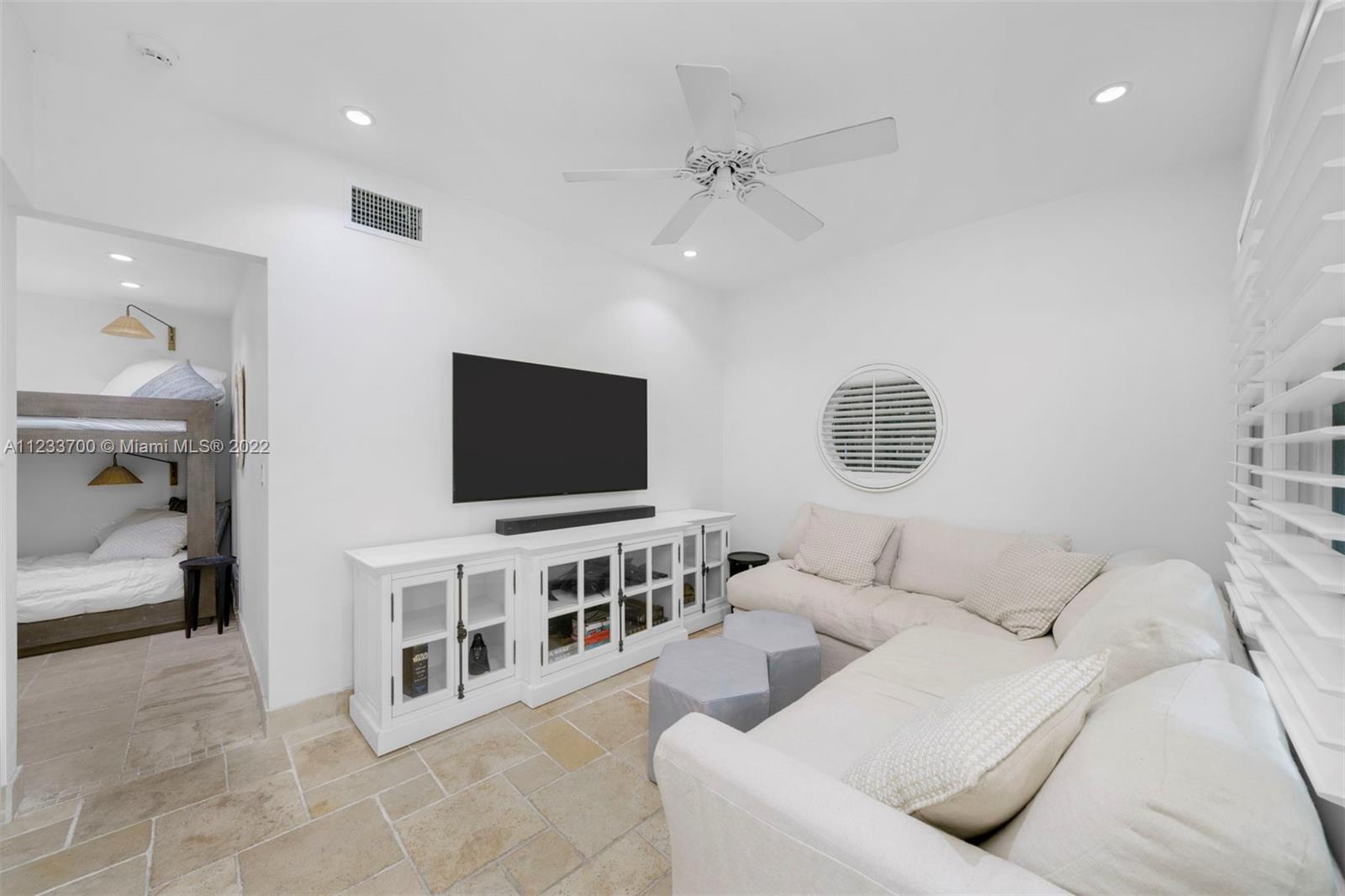 3618 St Gaudens Road Miami, FL 33133 - Photo 34 of 38 a living room with furniture and a flat screen tv