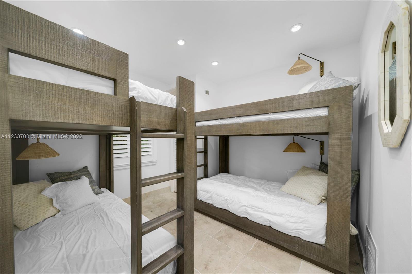 3618 St Gaudens Road Miami, FL 33133 - Photo 35 of 38 a bedroom with a bed and a lamp