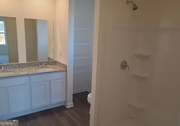a bathroom with a granite countertop sink and mirror