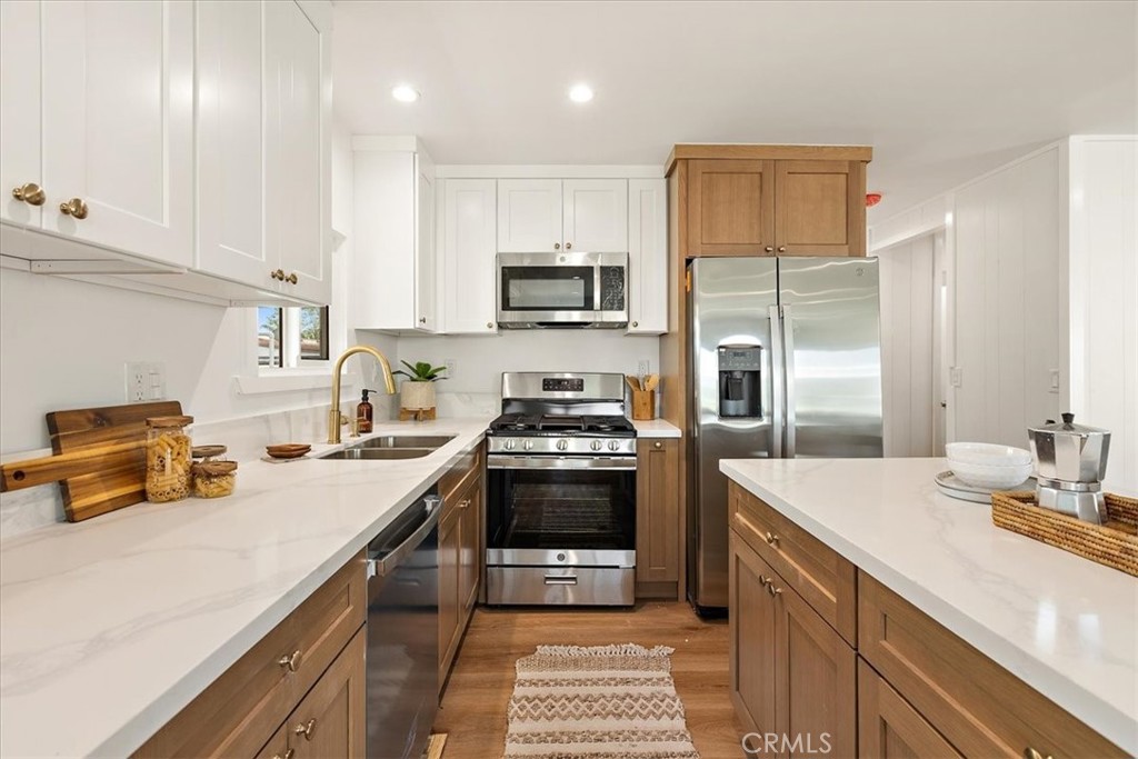 1001 West Lambert Road, Unit 110 La Habra, CA 90631 - Photo 12 of 39 a kitchen with stainless steel appliances a stove sink and cabinets
