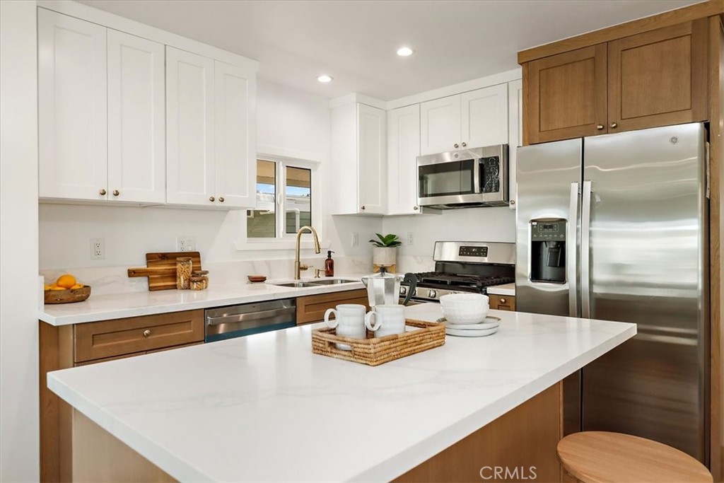 1001 West Lambert Road, Unit 110 La Habra, CA 90631 - Photo 14 of 39 a kitchen with a sink a stove and chairs