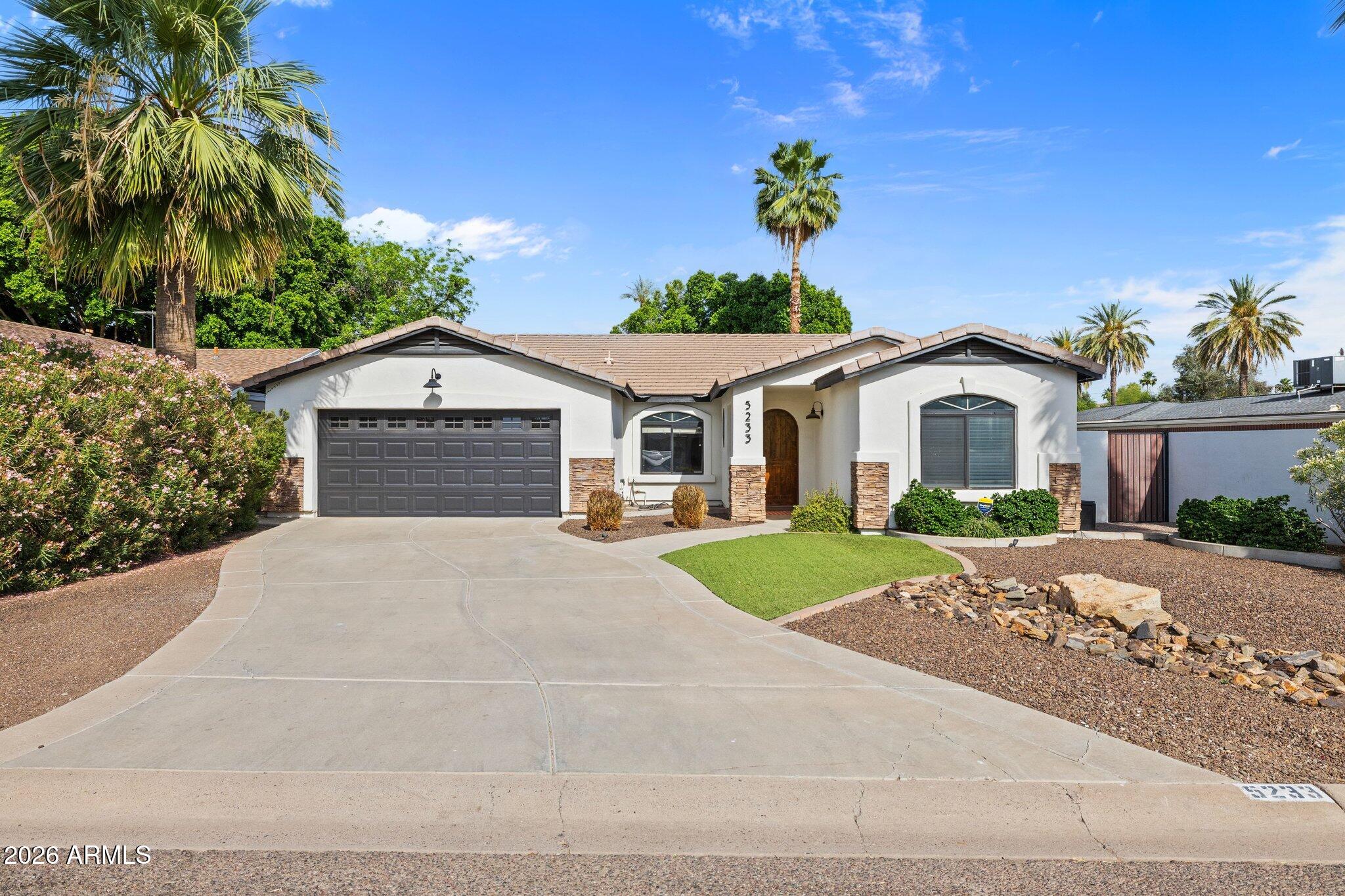 a front view of a house with a yard and garage