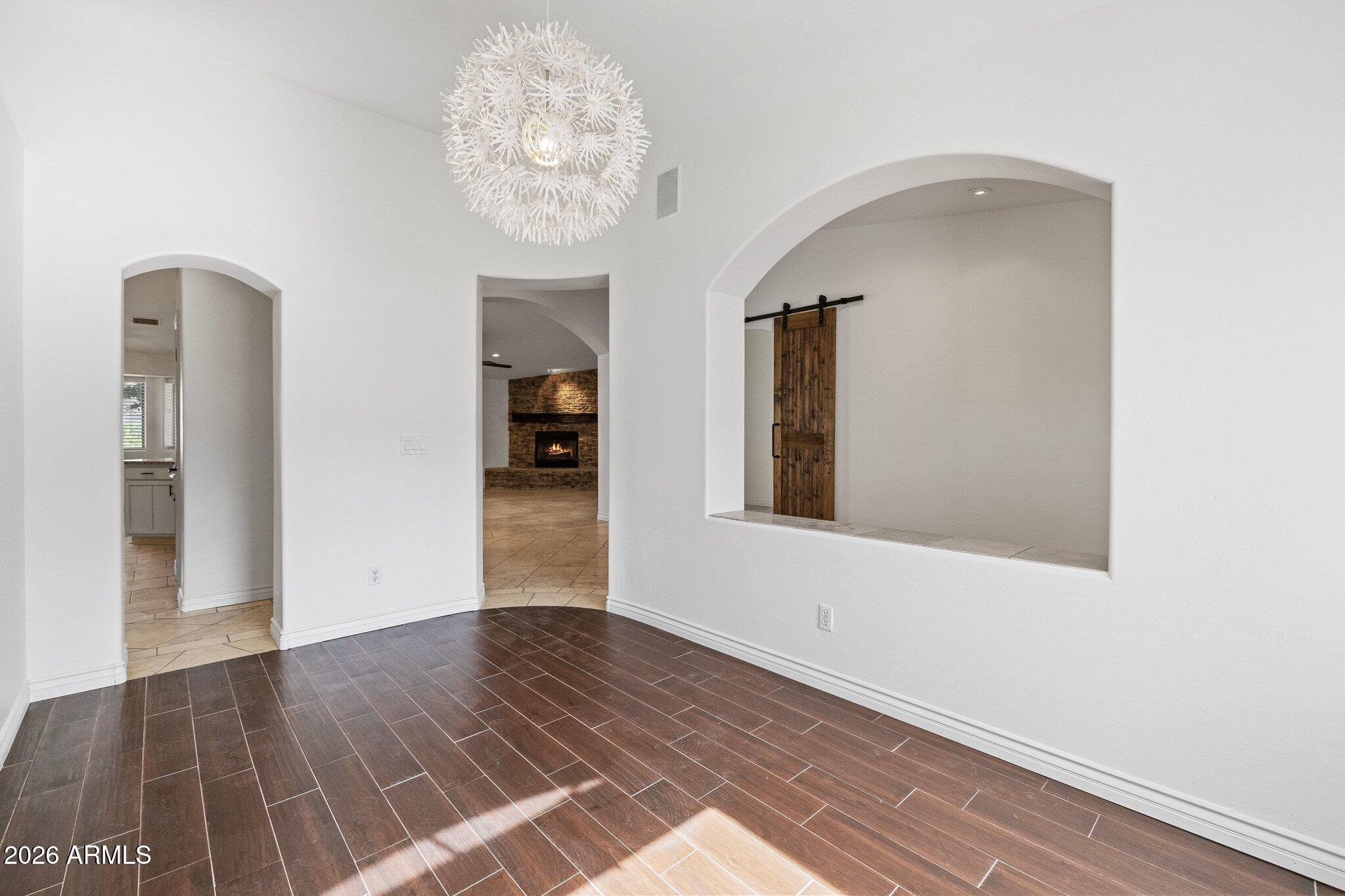 5233 North 15th Street Phoenix, AZ 85014 - Photo 11 of 26 a view of an empty room with wooden floor and a window