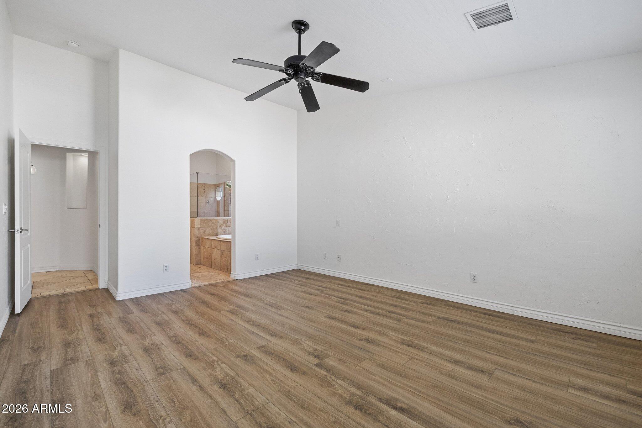 5233 North 15th Street Phoenix, AZ 85014 - Photo 12 of 26 a view of empty room with wooden floor and ceiling fan