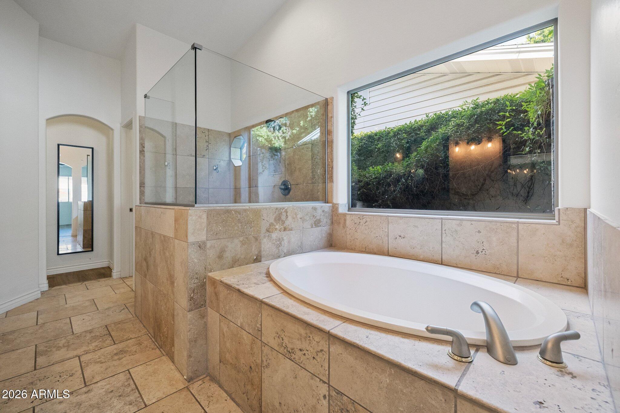 5233 North 15th Street Phoenix, AZ 85014 - Photo 13 of 26 a bathroom with a tub and a large window
