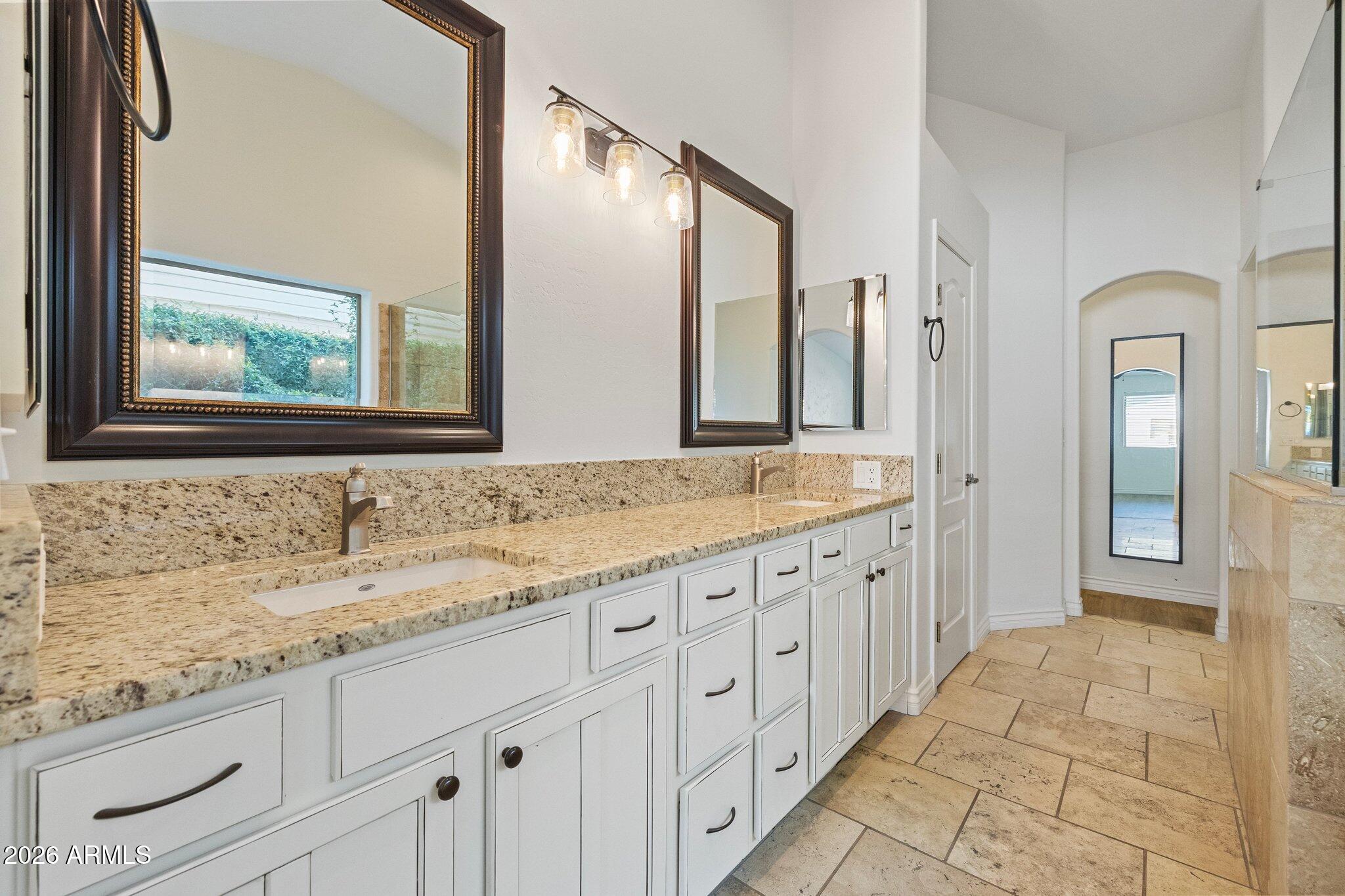 5233 North 15th Street Phoenix, AZ 85014 - Photo 14 of 26 a bathroom with double sink and a mirror