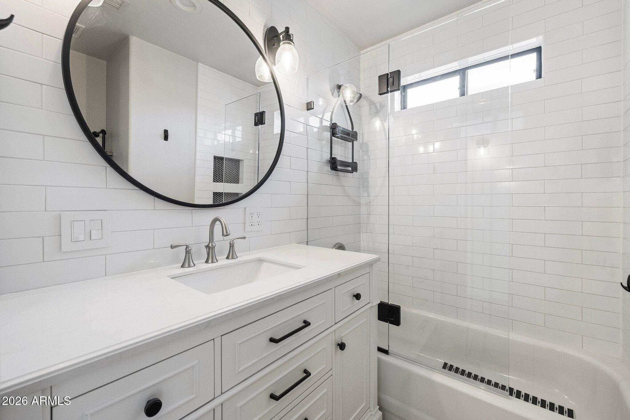 5233 North 15th Street Phoenix, AZ 85014 - Photo 19 of 26 a bathroom with a sink and a mirror