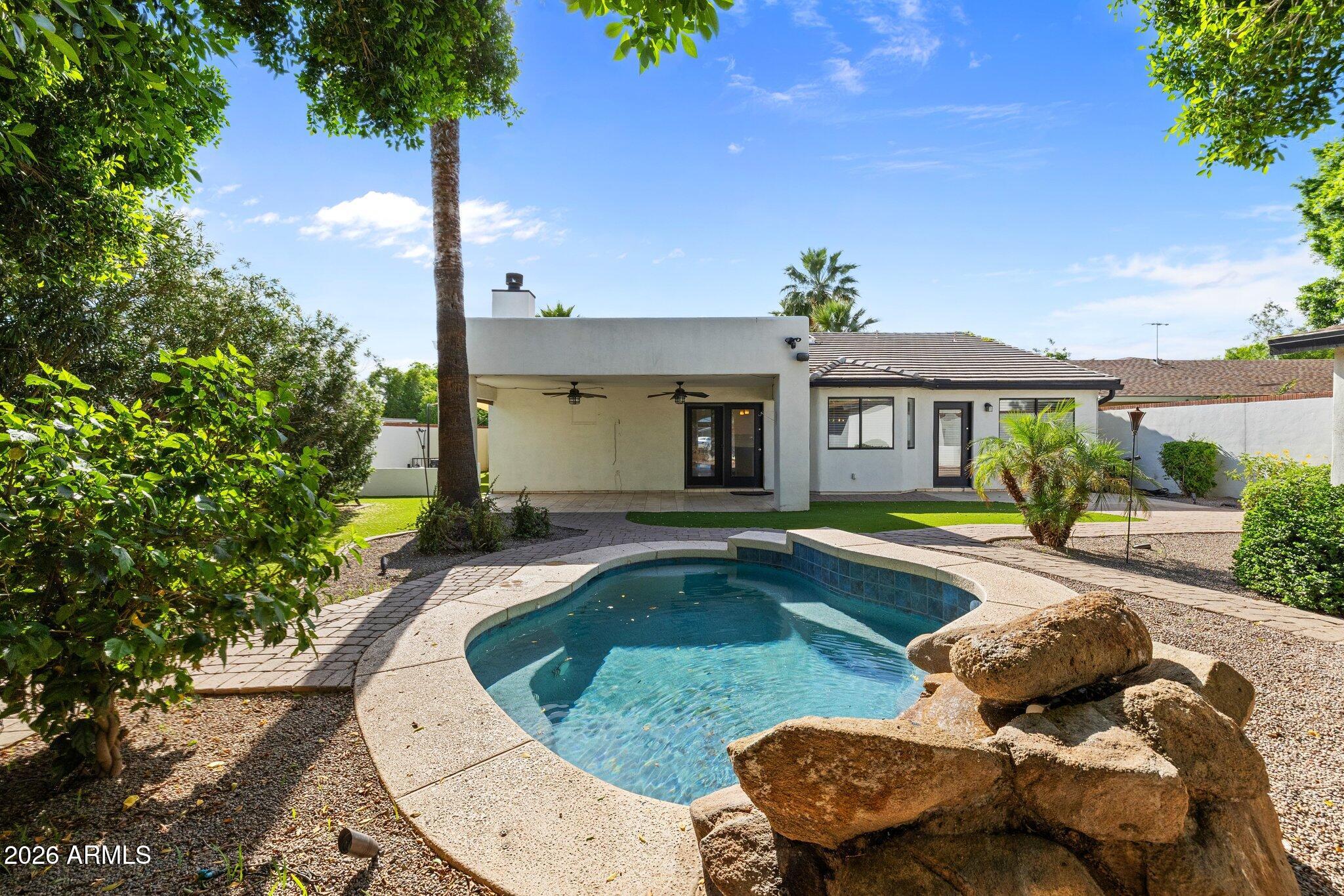 5233 North 15th Street Phoenix, AZ 85014 - Photo 20 of 26 a view of a house with swimming pool and a porch