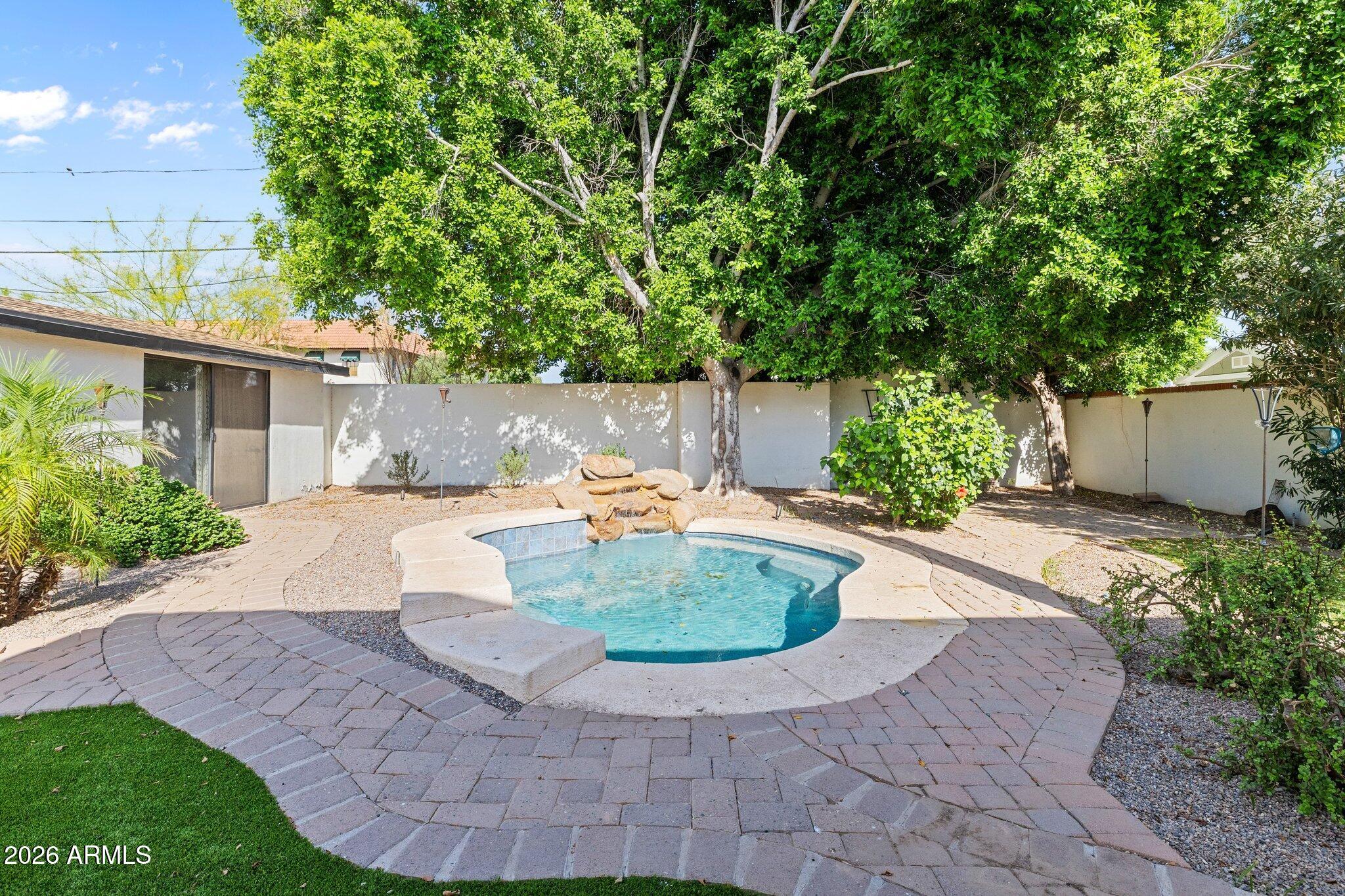 5233 North 15th Street Phoenix, AZ 85014 - Photo 22 of 26 a view of a backyard with potted plants and large trees