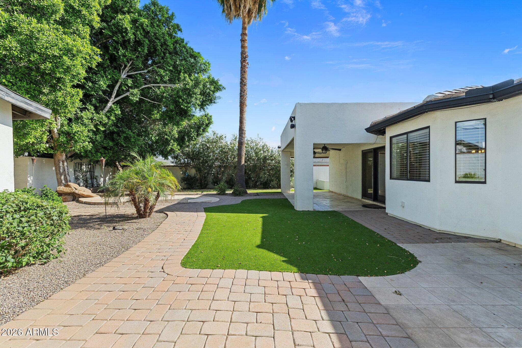 5233 North 15th Street Phoenix, AZ 85014 - Photo 23 of 26 a view of a house with backyard porch and garden
