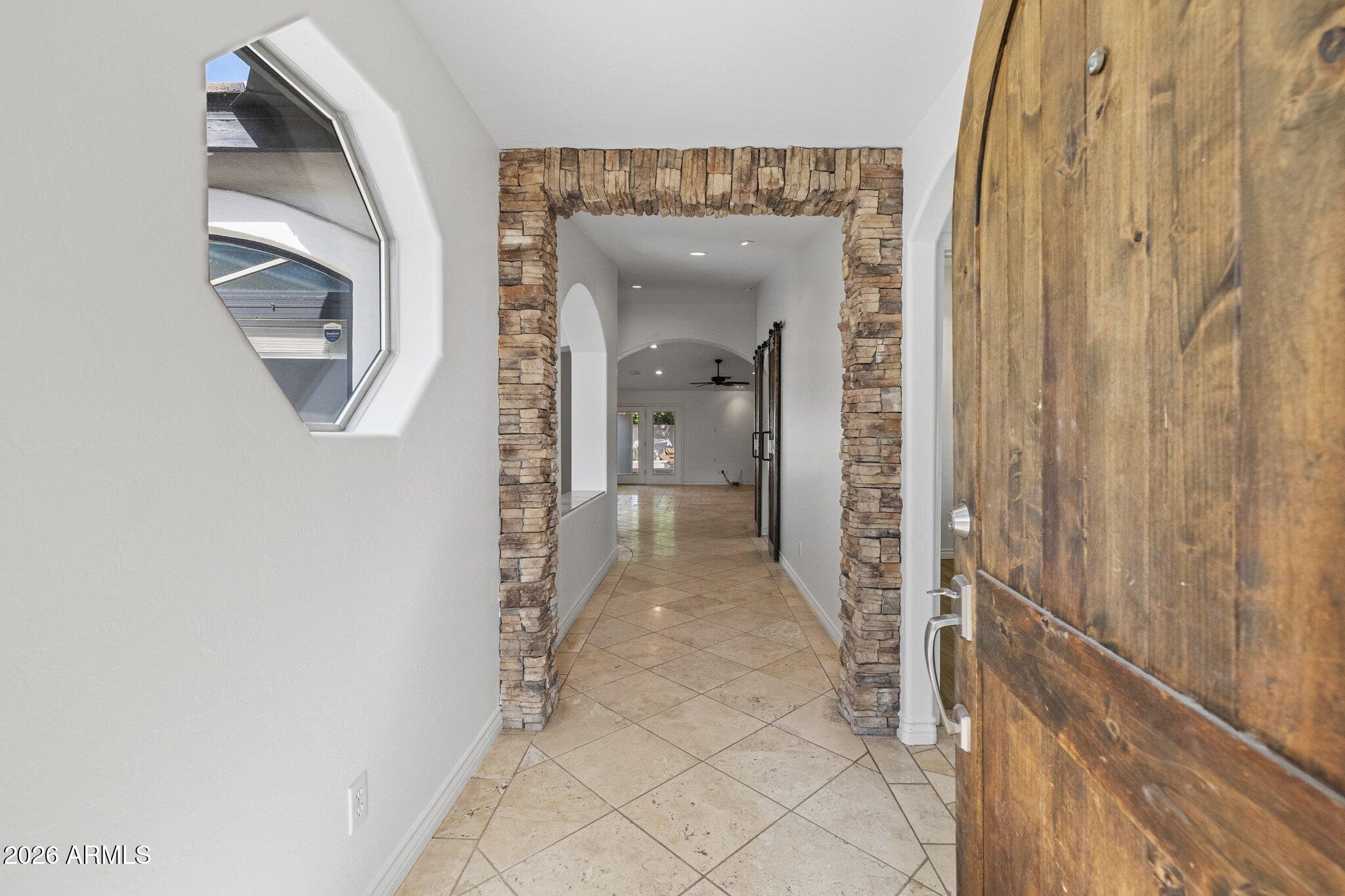 5233 North 15th Street Phoenix, AZ 85014 - Photo 25 of 26 a view of a hallway with wooden floor and a living room