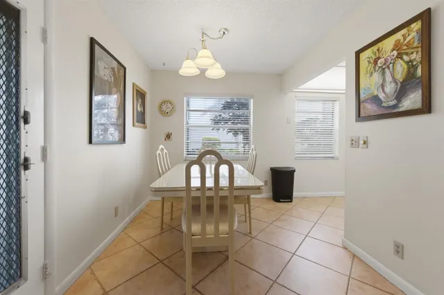 a kitchen with a sink a window and cabinets