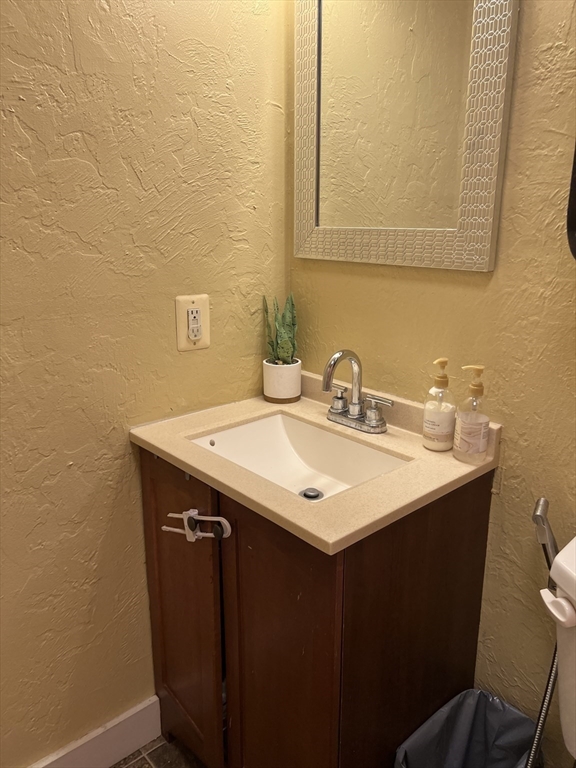 17 Federal Street, Unit 606 Worcester, MA 01608 - Photo 16 of 24 a bathroom with a sink and a mirror
