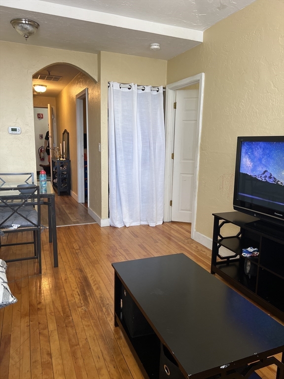 17 Federal Street, Unit 606 Worcester, MA 01608 - Photo 2 of 24 a bedroom with a bed and a flat screen tv