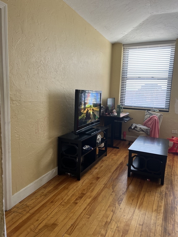 17 Federal Street, Unit 606 Worcester, MA 01608 - Photo 3 of 24 a living room with furniture and a flat screen tv