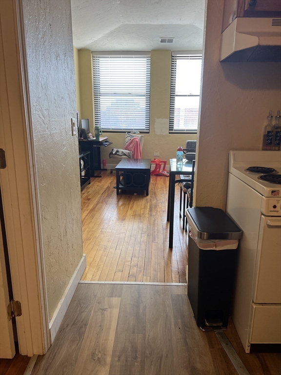 17 Federal Street, Unit 606 Worcester, MA 01608 - Photo 5 of 24 a kitchen with a refrigerator and a stove