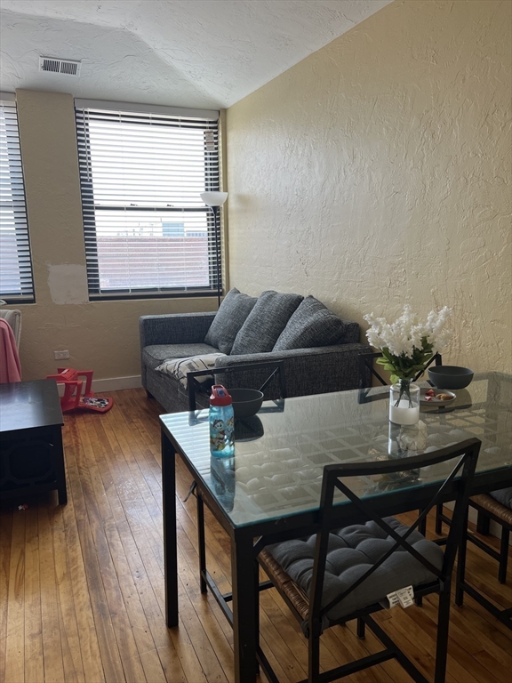 17 Federal Street, Unit 606 Worcester, MA 01608 - Photo 6 of 24 a living room with furniture and wooden floor