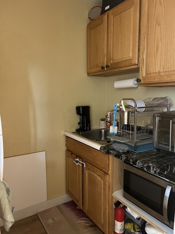 17 Federal Street, Unit 606 Worcester, MA 01608 - Photo 9 of 24 a kitchen with stainless steel appliances granite countertop a stove and a microwave