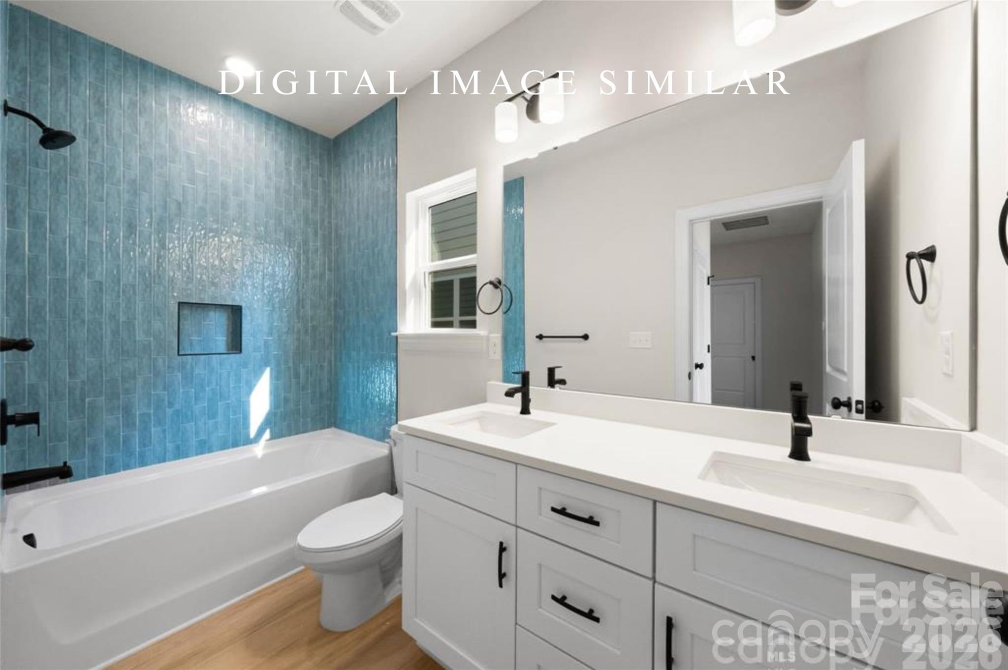 2928 Mulberry Church Road Charlotte, NC 28208 - Photo 33 of 43 a bathroom with a toilet a sink a tub and a mirror