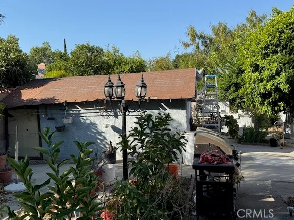 an aerial view of a house with yard and seating space